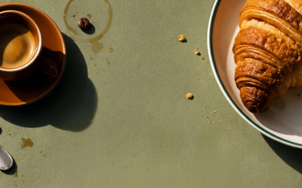 LuBlu Bakery & Cafe — coffee, croissants and pastries laid out on an olive linen